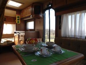 a table with plates of food on it in a kitchen at Granichar 1 Caravan in Granichar