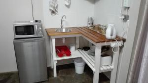 a small kitchen with a sink and a microwave at Dreams in Beaufort West