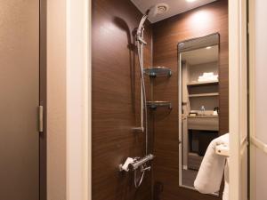 a bathroom with a shower with a mirror at S.Training Center Hotel Osaka in Osaka