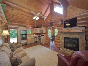 a living room with a couch and a fireplace at Bearly Lovers in Gatlinburg