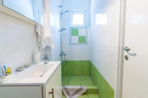 a bathroom with a sink and a shower at Stathopoulos Apartments in Sampatiki +27 photos
