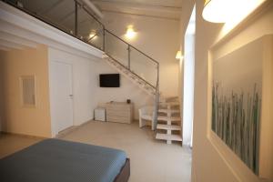 a room with a bed and a staircase in it at Italiana Resort Maniace in Siracusa