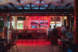 a group of people sitting at a bar in a restaurant at Apartments Casablanca in Podstrana