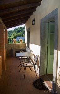 a patio with a table and chairs and a window at La Casatorre Di Ponticello in Filattiera