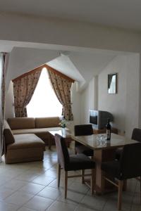 a living room with a table and a couch at Villa Nestor in Struga