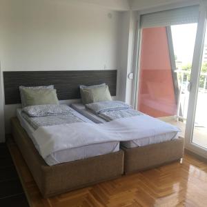 a bed with two pillows on it in a bedroom at S&N Apartment in Ohrid