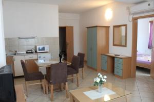 a living room with a kitchen and a dining room at Villa Nestor in Struga