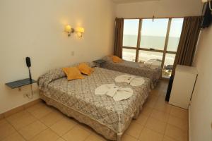 a bedroom with a bed and a view of the ocean at Hotel SKY in San Bernardo