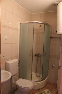 a bathroom with a shower with a toilet and a sink at Villa Nestor in Struga +28 photos