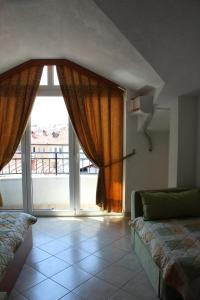 a room with a bed and a large window at Villa Nestor in Struga