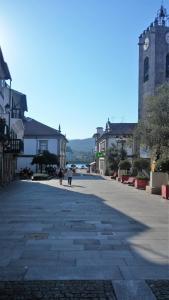 an empty street in a town with a clock tower at casa cardeal saraiva in Ponte de Lima