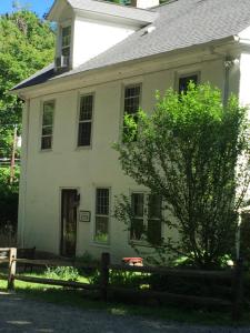 a white house with a wooden fence in front of it at Innkeeper's Place B&B in Stafford Springs