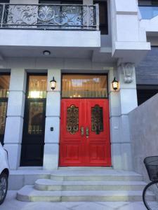 a red front door of a building with stairs at Angel Wings Inn in Hualien City