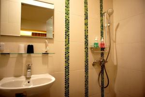 a bathroom with a sink and a shower at Simonhall B&B in Tainan