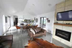 a living room with a couch and a fireplace at Ohaupo Olives in Ohaupo