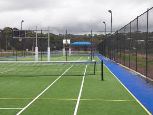 a tennis court with two tennis courts at The Anchorage Cottage Kangaroo Island in American River