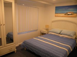 a small bedroom with a bed and a window at The Anchorage Cottage Kangaroo Island in American River