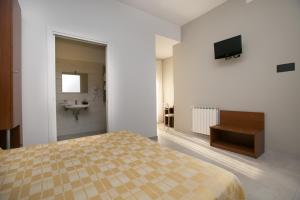 En eller flere senger på et rom på Albergo Arcobaleno