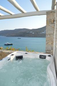 a hot tub with a view of the water at Sea Side Studios & Houses in Kalo Livadi