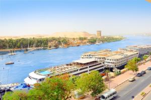 a large body of water with a cruise ship at Nile Hotel Aswan in Aswan