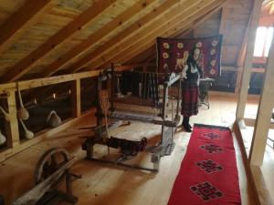 a woman standing in a room in a attic at Country house Todor in Kragujevac
