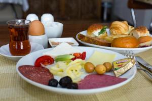 a table with three plates of food and a drink at My Kent Hotel in Istanbul