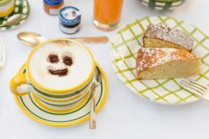 a cup of coffee and a plate of bread at Relais Regina Giovanna in Sorrento