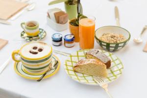 a table with a plate of bread and a cup of orange juice at Relais Regina Giovanna in Sorrento