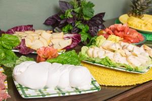 a table topped with plates of food with vegetables at Relais Regina Giovanna in Sorrento