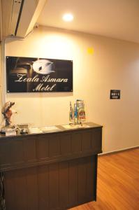 a bar in a restaurant with a sign on the wall at Zeala Asmara Motel in Kuah