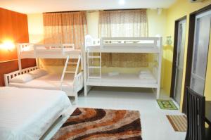 a room with two bunk beds and a rug at Zeala Asmara Motel in Kuah +45 photos