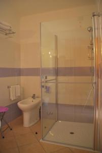 a bathroom with a shower and a toilet at Hotel Turismo Rurale Villa Maria Caterina in Cala Gonone