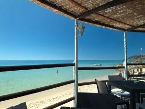 a view of the beach from a restaurant at Abamar Hotel in Santa Margherita di Pula