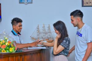 a group of people standing around a table with a boat at Nebula Residence in Negombo +63 photos