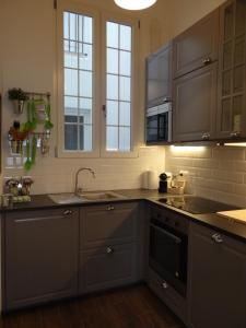a kitchen with a sink and a stove top oven at Valencia what else... in Valencia