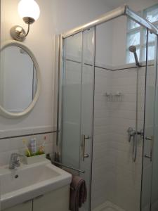 a bathroom with a sink and a glass shower at Valencia what else... in Valencia