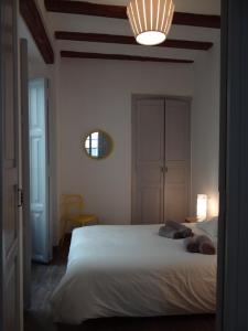 a bedroom with a large white bed with a light at Valencia what else... in Valencia