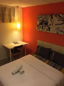 a bedroom with a bed and a desk and a table at 7 Star Hotel in Kota Damansara