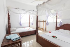 Tempat tidur dalam kamar di Kite&Active Guesthouse