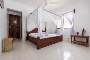 Tempat tidur dalam kamar di Kite&Active Guesthouse