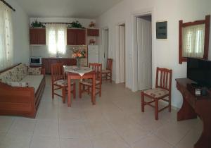 a kitchen and living room with a table and chairs at Eirini- Ioanna in Sami