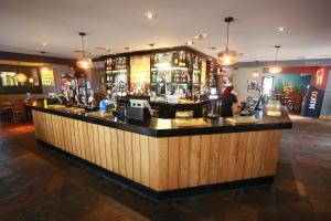 a bar in a pub with a counter top at Willows, Blackburn by Marston's Inn in Blackburn