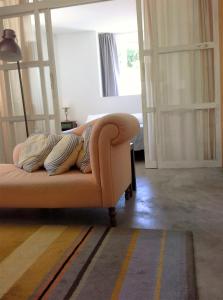 a couch sitting in a living room with a window at Apartments Uppe Villa in Lisbon