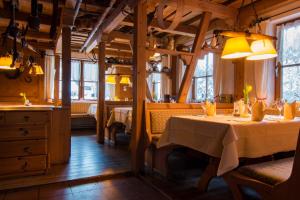 a dining room with a table in a restaurant at Hotel & Restaurant Grüner Baum - Die Grüne Oase Am Feldberg in Feldberg