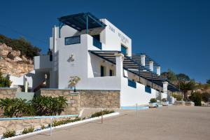 a white building with stairs on the side of it at B & N Melas Studios in Amoopi