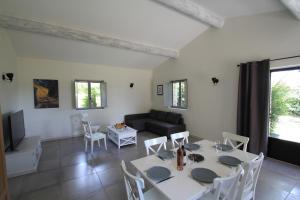 a living room with a table and chairs and a couch at La Caprine in Gordes +16 photos