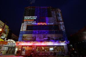 a tall building with blue lights on top of it at Hotel Sitara Grand Ramchandrapuram in Hyderabad