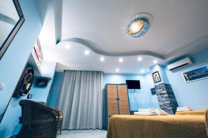 a blue room with a bed and a fireplace at B&B Sunshine in Scilla