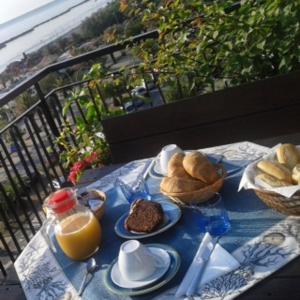a blue table with bread and orange juice on it at B&B Attico Mare in San Benedetto del Tronto