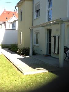 a white house with a driveway in front of it at Apartment Alexander Bad Kreuznach in Bad Kreuznach